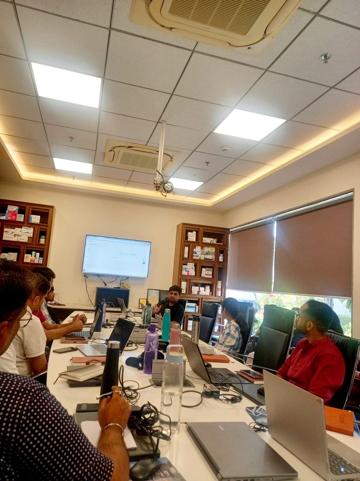 Hands-on AI training session at Sundyota Numandis Pharmaceuticals, participants at laptops around a conference table